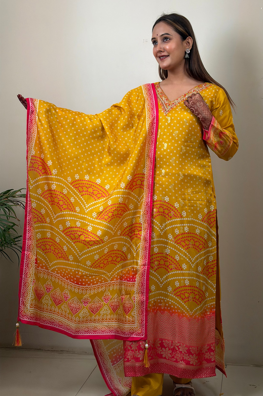 Woman holding a yellow and pink patterned dupatta against a plain background