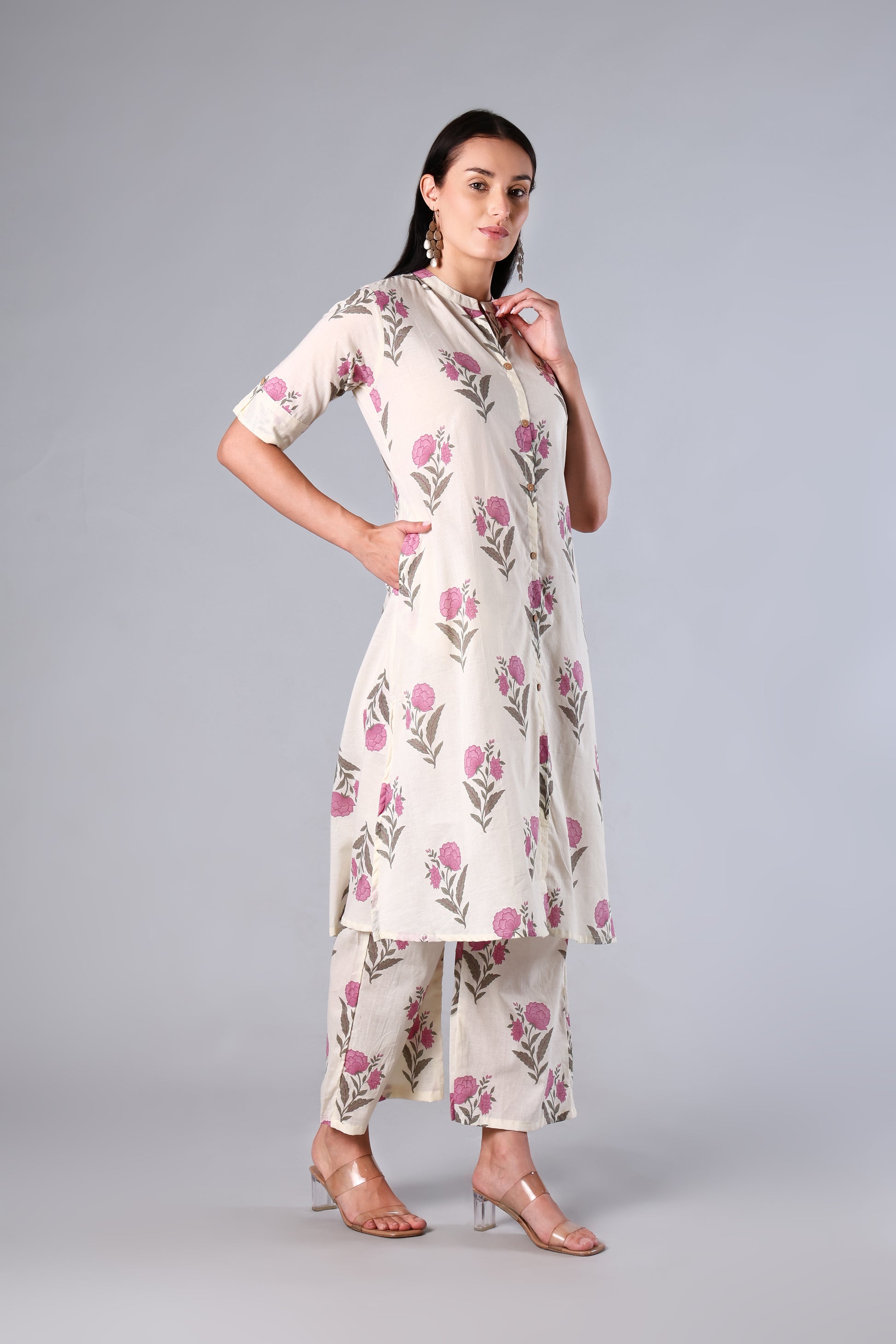 Woman wearing a Pink floral dress with a plain background