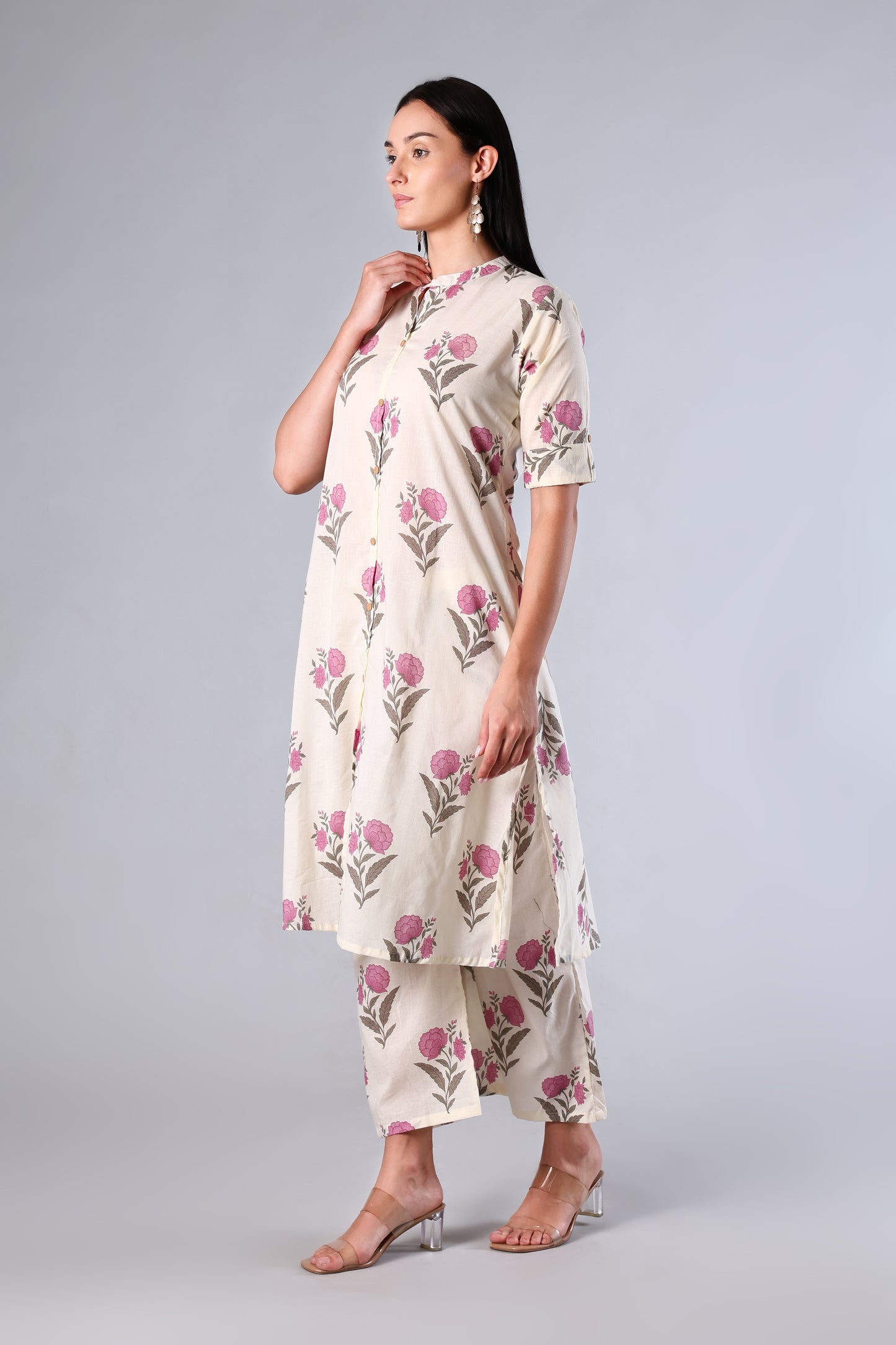 Woman wearing a Pink floral dress on a gray background