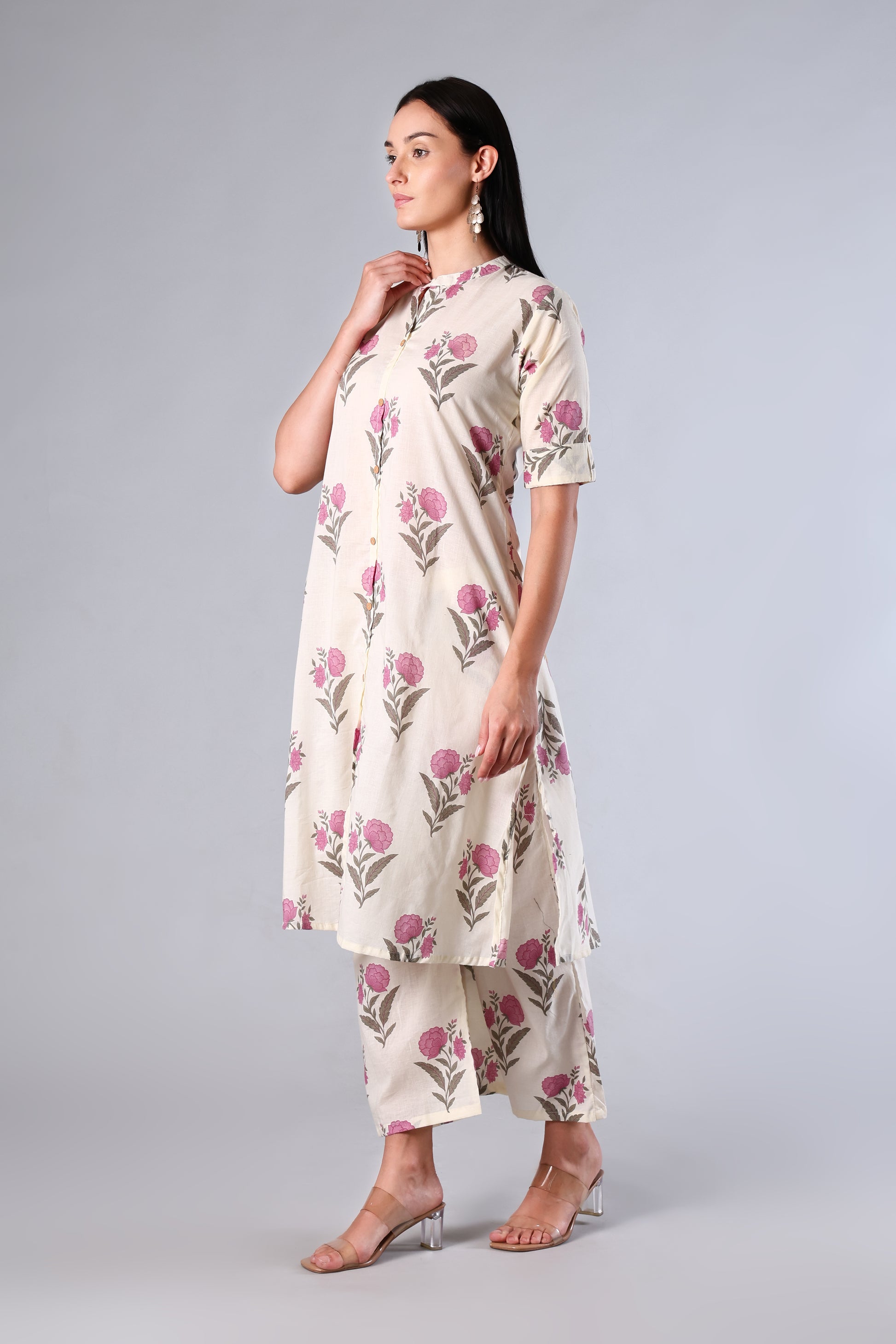 Woman wearing a Pink floral dress on a gray background