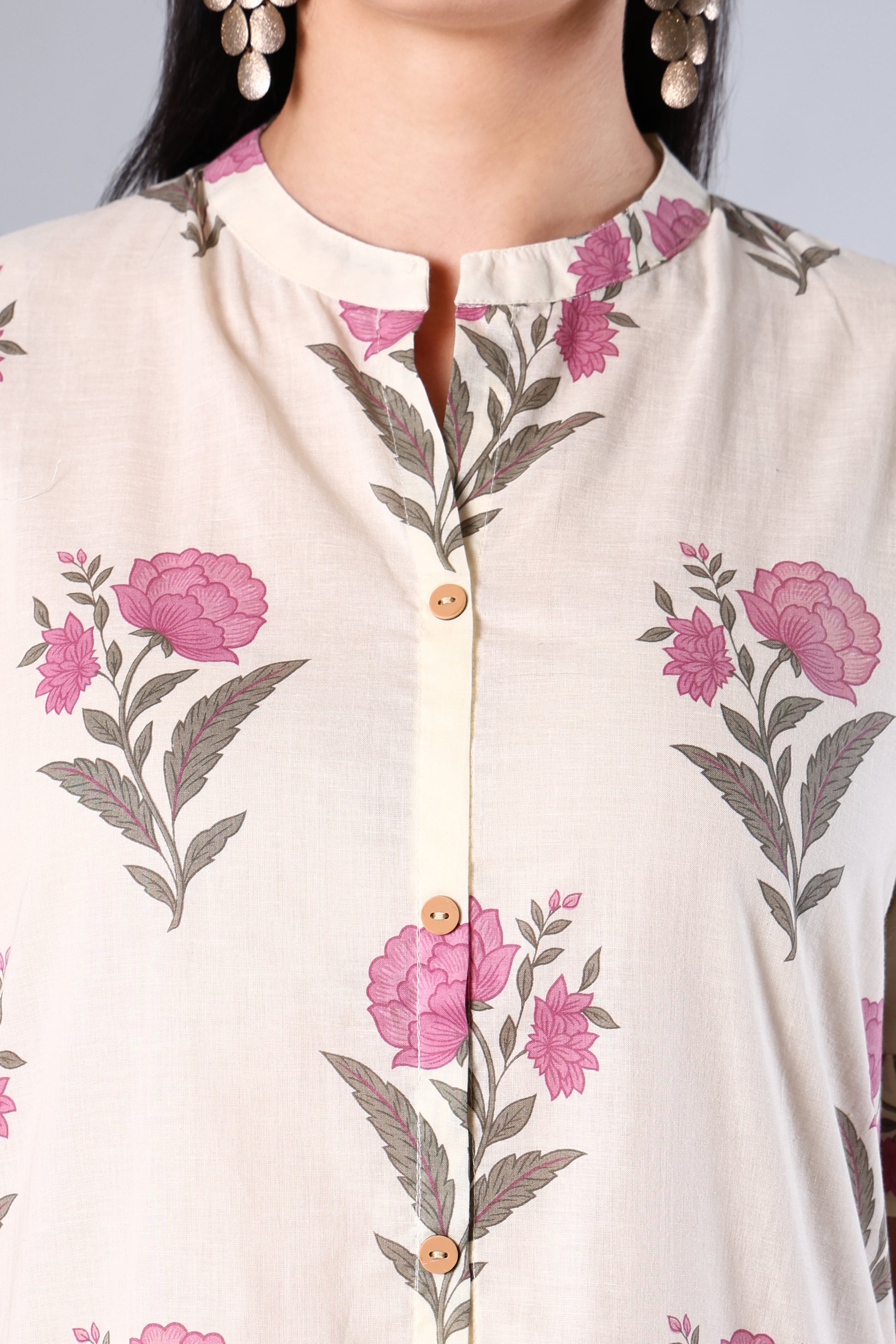 Close-up of a Pink -colored shirt with pink floral patterns on a plain background
