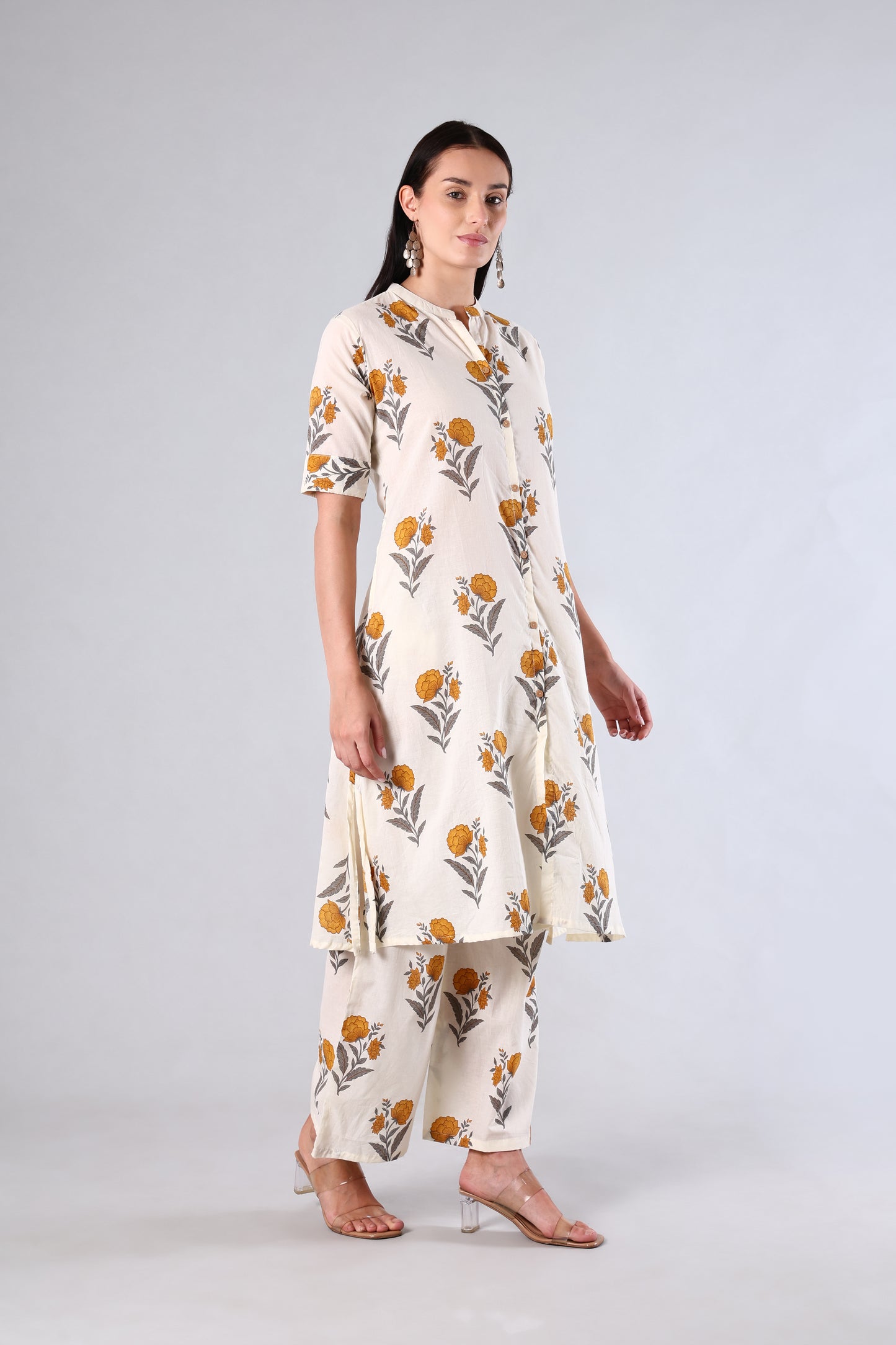 Woman wearing a Yellow floral printed outfit on a white background