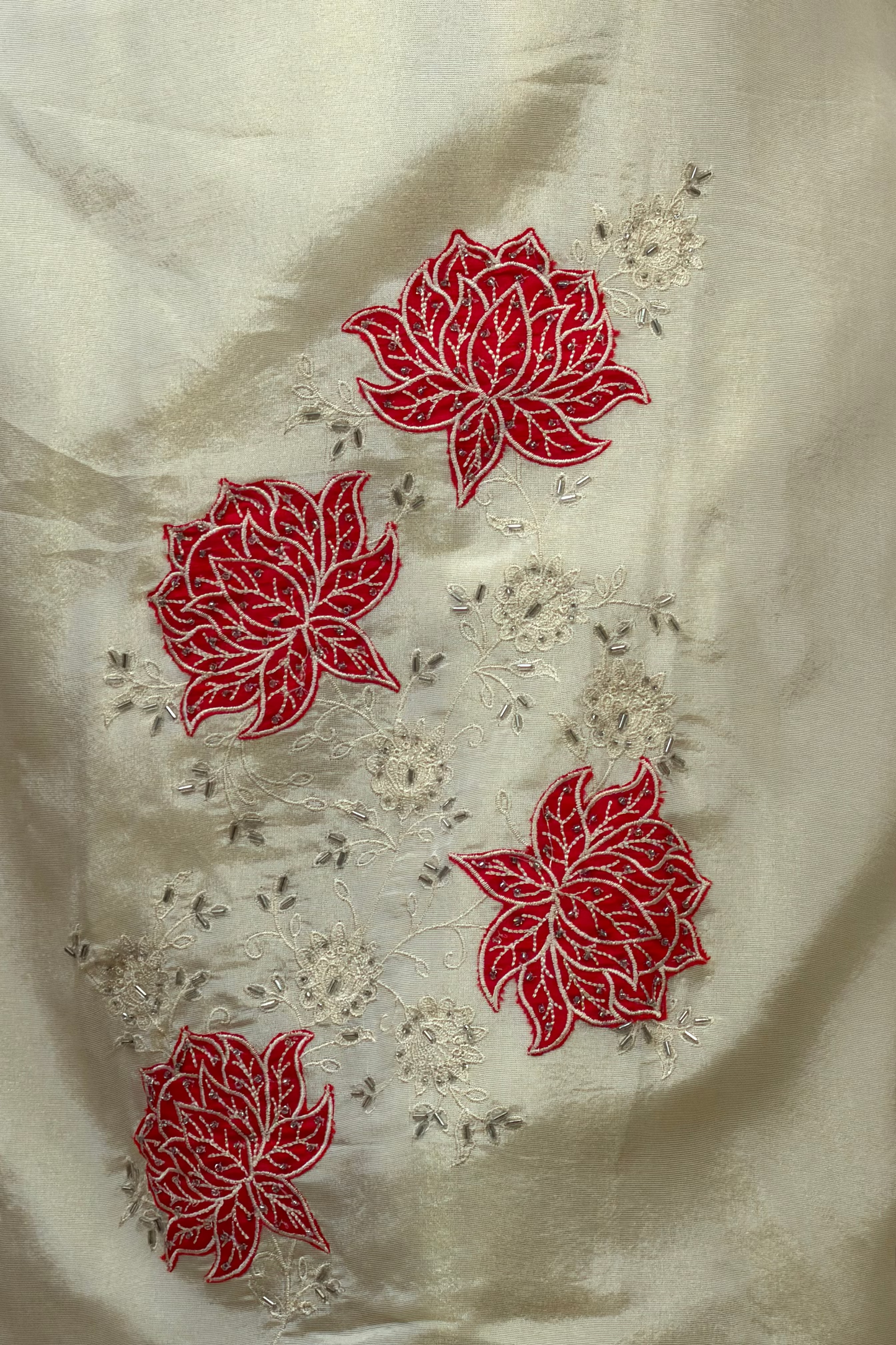 White fabric with red floral embroidery