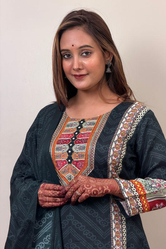 Woman wearing a traditional embroidered outfit with a plain background