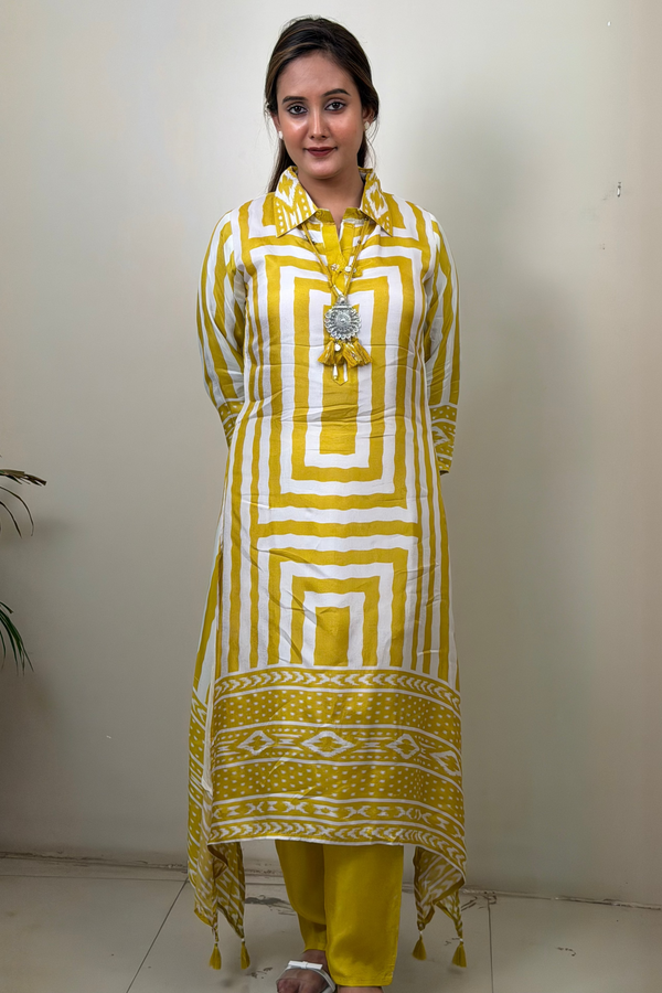 Woman wearing a yellow and white patterned kurta with matching pants against a plain background